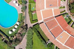 an overhead view of a house with a pool at Capo Ceraso Family Resort in Costa Corallina