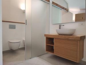 a bathroom with a sink and a toilet at Capo Ceraso Family Resort in Costa Corallina