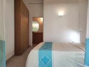 a bedroom with a large bed and a window at Capo Ceraso Family Resort in Costa Corallina