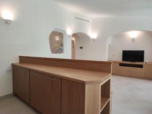 a room with a reception desk and a television at Capo Ceraso Family Resort in Costa Corallina