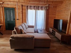 a living room with a couch and a television at Bungalovi Spahic in Ulcinj