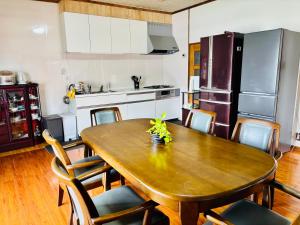 a kitchen with a wooden table with chairs around it at 和邸 和楽 Waraku in Kurume