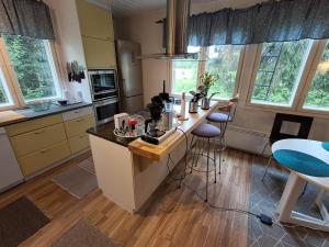 a kitchen with a island with a counter top at Pet Friendly Retreat - Sleeps 8 with Sauna in Koivisto