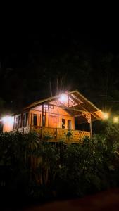 a house with lights on top of it at night at Melrimba Garden in Tengahgirang