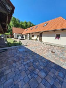 a brick driveway in front of a house at Apartmán Loft in Párnica