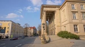 a building on a street with a street light in front at Anton-Ulrich Apartment in Meiningen