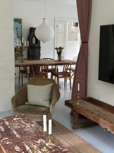 a living room with a chair and a table at Beautiful Villa in Klampenborg in Klampenborg