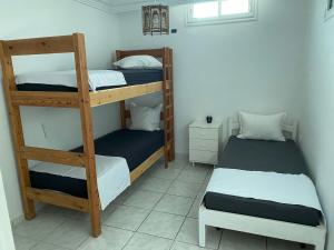 a room with two bunk beds and a table at Habibi-Danydan La Chebba in Chebba
