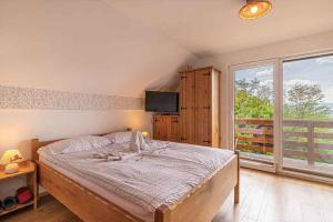a bedroom with a bed and a large window at Holiday home in Novo Mesto - Dolenjska Bela krajina Unter- Weißkrain 35158 in Novo Mesto
