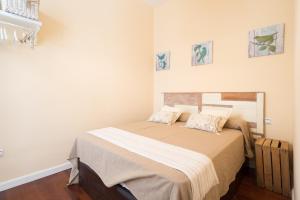 a bedroom with a bed with two pillows on it at Letmalaga Calderón in Málaga