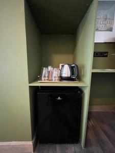 a kitchen with a counter with a toaster on a shelf at Central Guest Rooms in Amsterdam