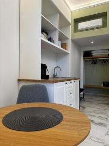 a table and chairs in a kitchen with a sink at Casa del Corso in Parghelia +8 photos