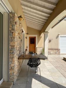 patio con tavolo e parete in pietra di Villa Nimes a Nîmes