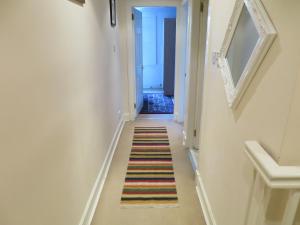 a hallway with stairs leading up to a staircase at Our City - King Stable Lane in Edinburgh