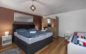a bedroom with a large bed and a mirror at 1 Bedroom Amazing Home In Ozalj in Ozalj