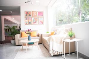 a living room with a couch and a table at Olive Serviced Apartments - HICC Hitex Hyderabad in Hyderabad