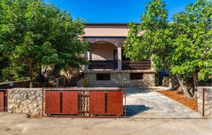 a house under construction with a fence in front of it at Beautiful Home In Starigrad - Paklenica With Wifi in Starigrad-Paklenica