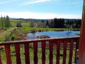 a view of a pond from the deck of a house at gîte des 1000 étangs in Saint-Bresson