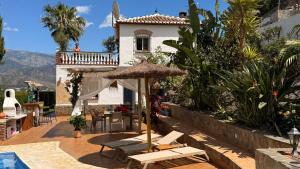 a villa with a swimming pool and a resort at Boutique Villa Jina, Private Pool, Mountain View, Near Nerja, Quiet Location, Mediterranean Garden in Torrox
