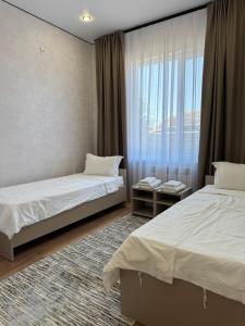 Ένα ή περισσότερα κρεβάτια σε δωμάτιο στο Comfort Altyn-Emel