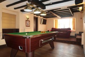 a living room with a pool table in a room at The Sun Inn in Whitfield