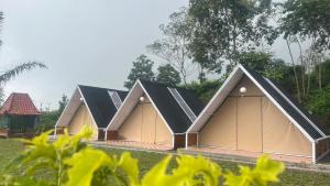 a row of houses with solar panels on their roofs at camping camp modern in Ciater