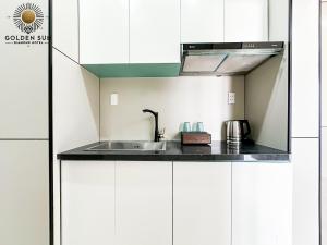 a kitchen with a sink and a microwave at Golden Sun Hotel 5 - Quận 2 in Ho Chi Minh City +37 photos