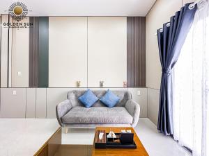 a living room with a couch and a table at Golden Sun Hotel 5 - Quận 2 in Ho Chi Minh City