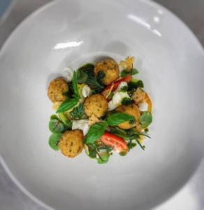 a white plate with a dish of food on it at Pen-Y-Dyffryn Country Hotel in Oswestry