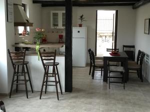 a kitchen with a table and chairs and a refrigerator at Mountain View Vacation Home in Balabanska