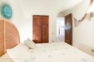 Кровать или кровати в номере Porto Cervo House, giardino e piscina condominiale