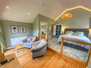 a bedroom with a bed and a living room at Pen-Y-Dyffryn Country Hotel in Oswestry