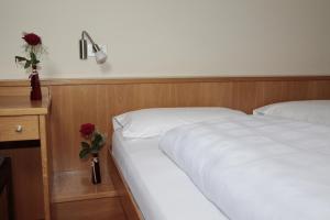 Postel nebo postele na pokoji v ubytování Hotel Alpino Plan