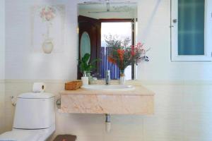 a bathroom with a sink and a toilet and a mirror at Lucky Star Hotel - Bui Vien Walking Street in Ho Chi Minh City +22 photos