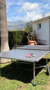 een pingpongtafel in het gras naast een huis bij Villa Jina in Torrox