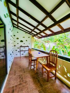a dining room with a table and two chairs at TipTop Hotel, Resto and Delishop in Panglao