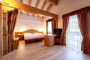 Posteľ alebo postele v izbe v ubytovaní Hotel Laurin