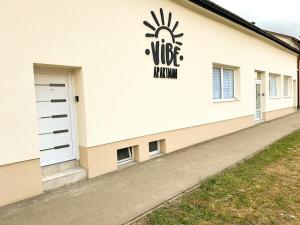a building with a sign on the side of it at VIBE S32 Apartman,AC,Free Parking in Székesfehérvár