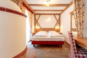 Posteľ alebo postele v izbe v ubytovaní Hotel Laurin