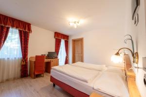 Posteľ alebo postele v izbe v ubytovaní Hotel Laurin