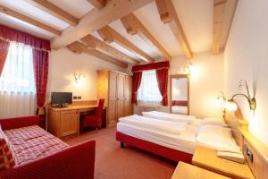 Posteľ alebo postele v izbe v ubytovaní Hotel Laurin