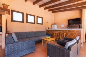 a living room with a couch and a bar at Can Palleta - Finca para 10 personas en el paraíso in Calonge