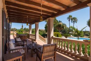 a patio with tables and chairs and a view of a pool at Can Palleta - Finca para 10 personas en el paraíso in Calonge