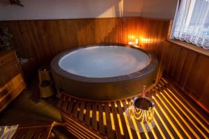 a large bath tub in a wooden room with a bench at Holiday home in Trebelno - Dolenjska & Bela krajina Unter- & Weißkrain 26032 in Trebelno