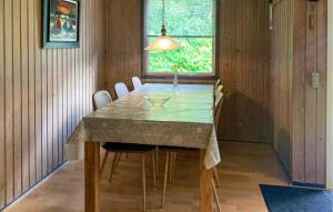 a dining room with a table and chairs and a window at 2 Bedroom Lovely Home In Silkeborg in Silkeborg