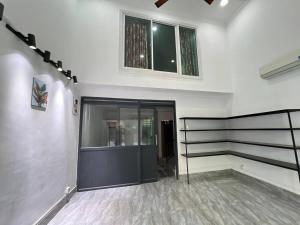 a hallway with a building with a door and windows at TL Apartment, Cambodia in Phnom Penh