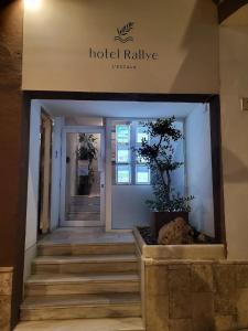 a hotel lobby with stairs in front of a building at Rallye Hotel in L'Escala
