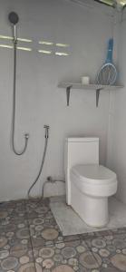 a white bathroom with a toilet and a shower at Ninja Camp - Dojo - Muay Thai Retreat in Baan Tai
