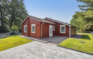 a small red house with a large driveway at Ferienhaus Haren in Haren +12 photos