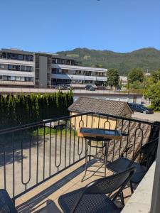 a table and chairs on a balcony with a gazebo at Apartment in the middle of the city center in a quiet street in Stryn